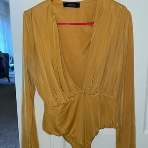 Long-sleeved, plunge neckline, yellow bodysuit.